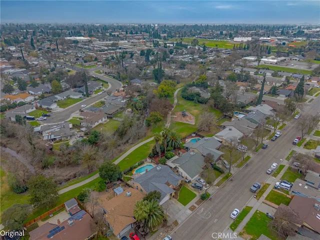 a view of a room with wooden floor and a ceiling fan