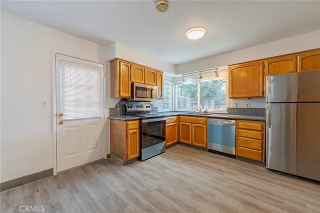 an empty room with a ceiling fan and a window