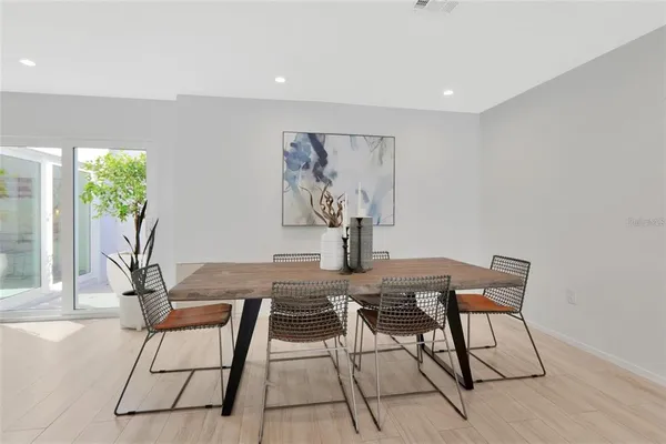 a view of a dining room with furniture and a potted plant