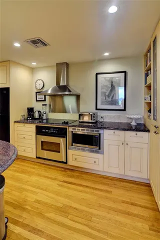 a kitchen with stainless steel appliances granite countertop a stove and a sink