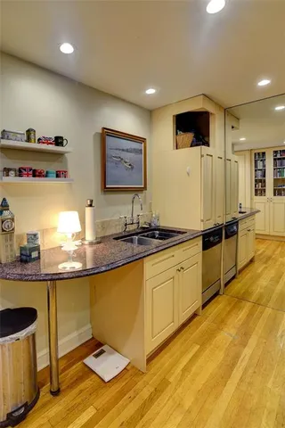 a large kitchen with stainless steel appliances granite countertop a sink and a wooden cabinets