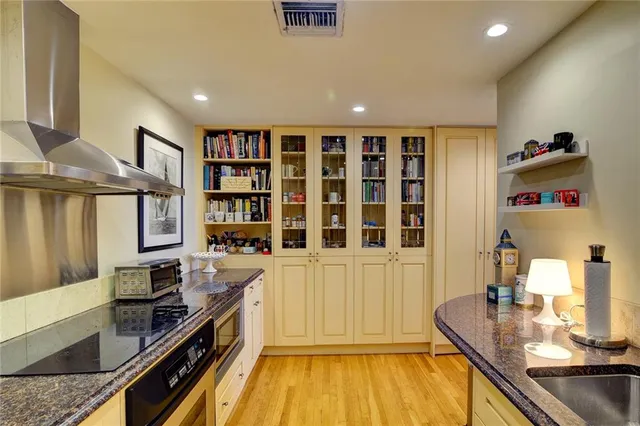 a kitchen with granite countertop a stove and a sink