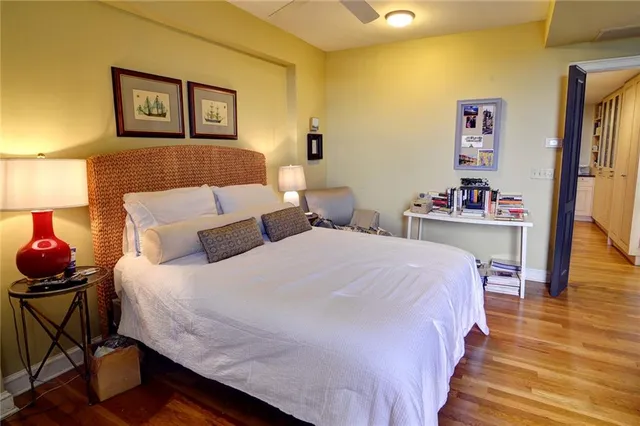 a bedroom with a bed and wooden floor