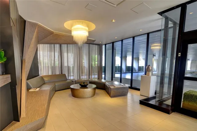 a living room with furniture and large windows