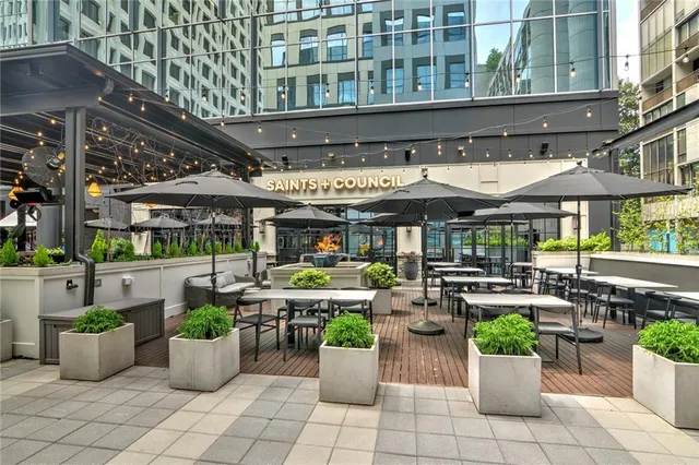 a view of a patio with plants and chairs