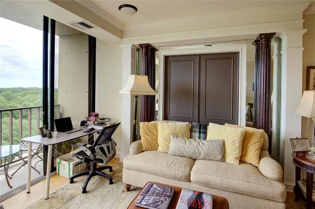 a living room with furniture and a floor to ceiling window