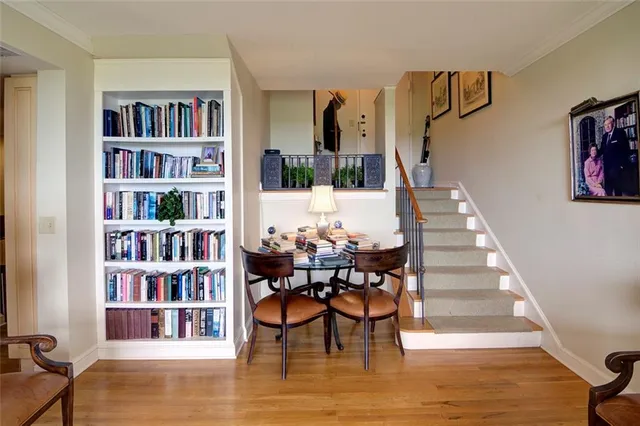 a living room with furniture and a book shelf
