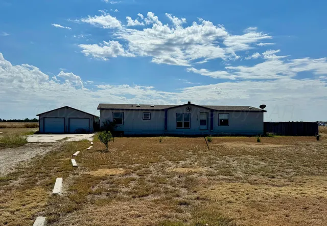 a big yard with table and chairs