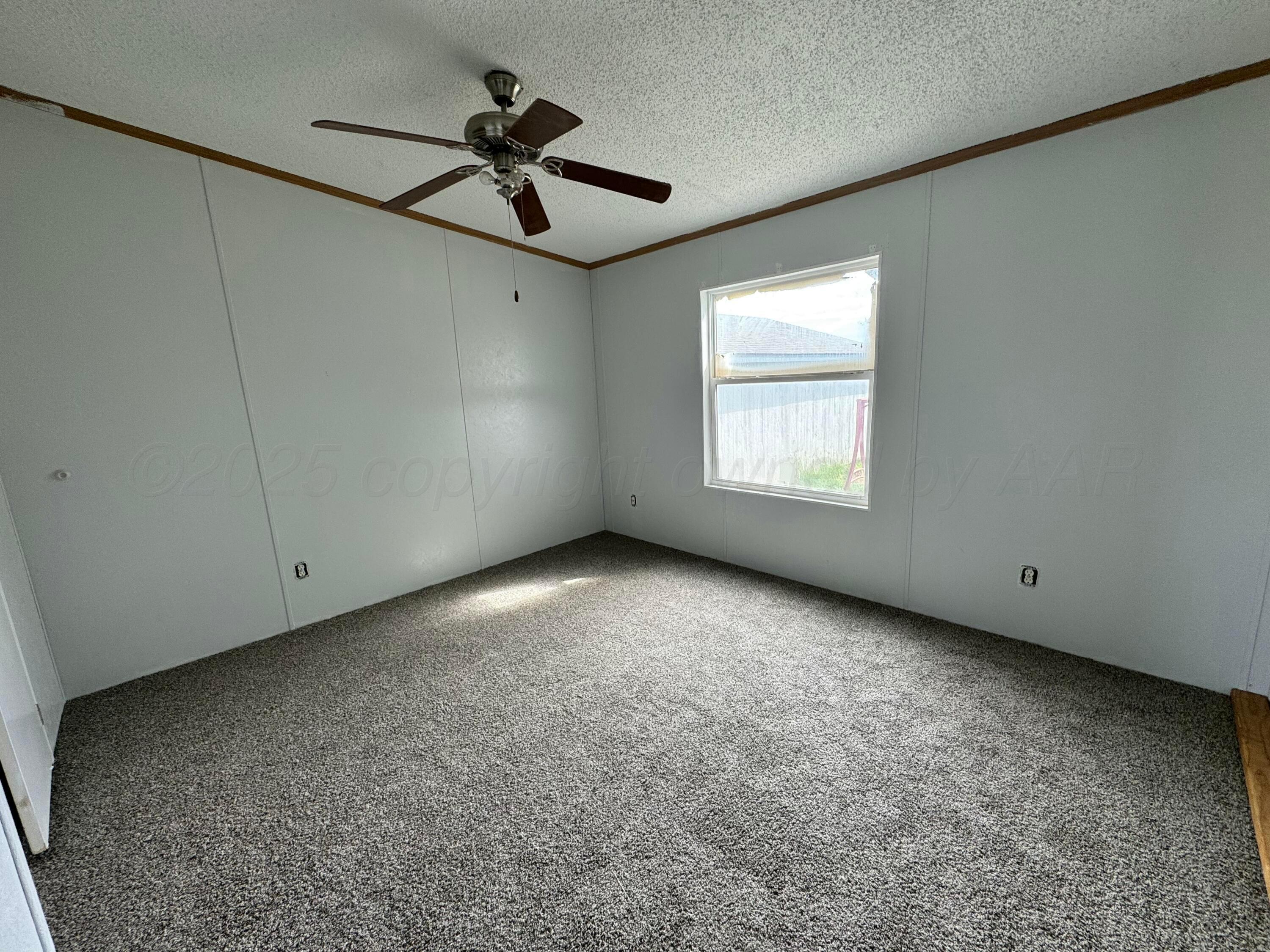 1501 Claude Road Amarillo, TX 79118 - Photo 4 of 7 a view of a livingroom with a ceiling fan and window