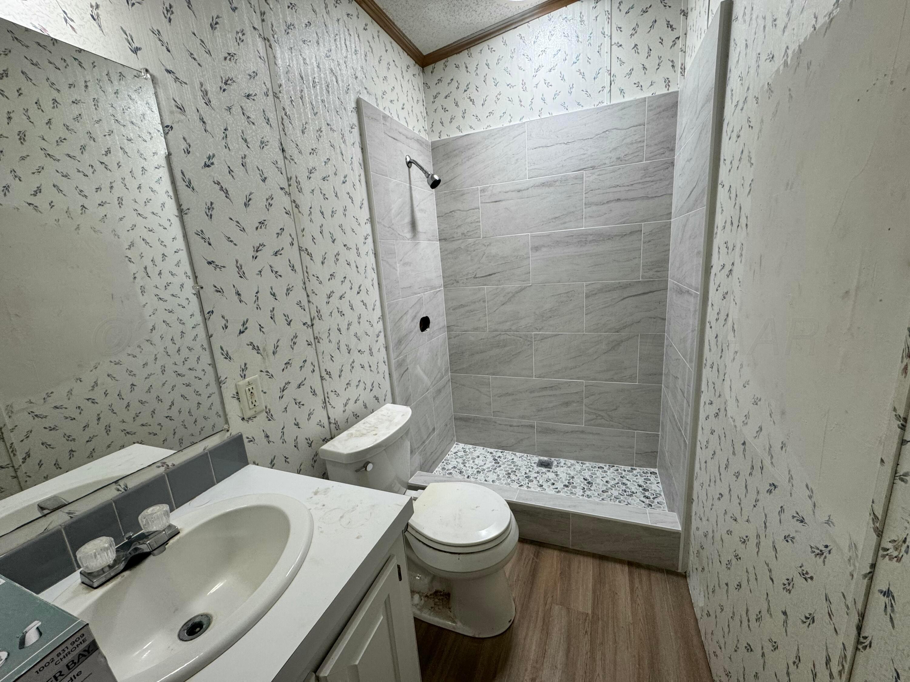 1501 Claude Road Amarillo, TX 79118 - Photo 5 of 7 a bathroom with a sink toilet and shower