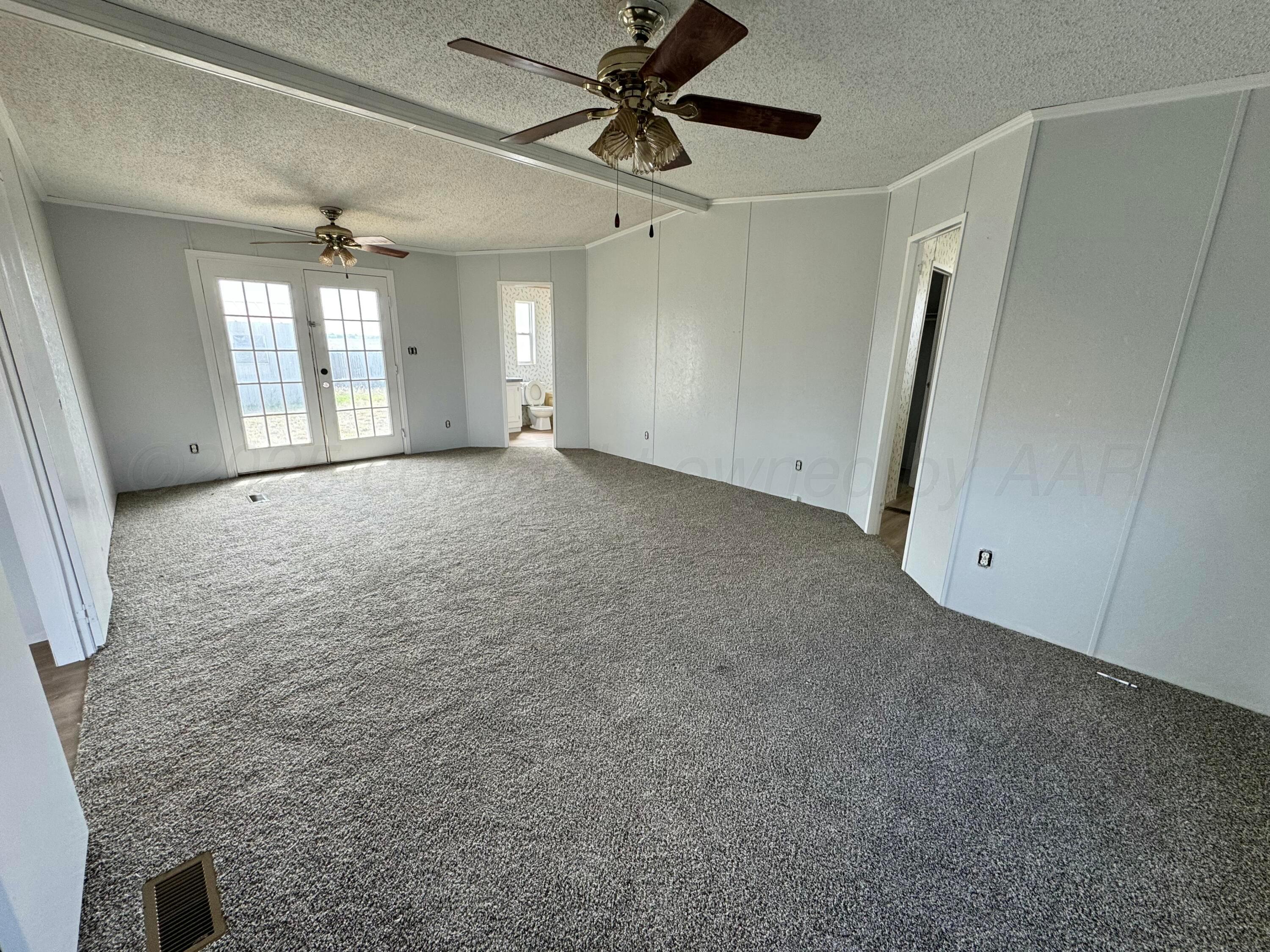 1501 Claude Road Amarillo, TX 79118 - Photo 6 of 7 a view of a big room with windows and ceiling fan