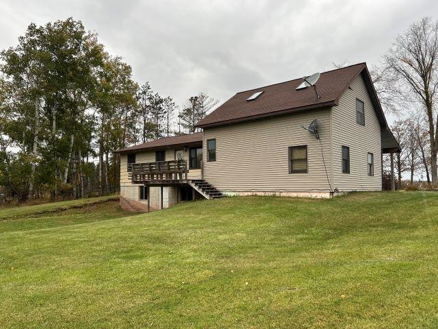8353 Mannik Road Iron River, WI 54847 - Photo 9 of 48 Back of house with a lawn, a wooden deck, and stairs