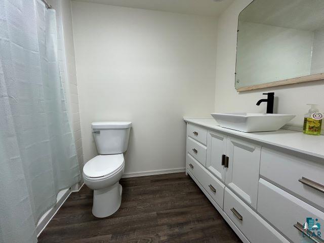 8353 Mannik Road Iron River, WI 54847 - Photo 11 of 48 Bathroom featuring vanity, dark wood-type flooring, and curtained shower