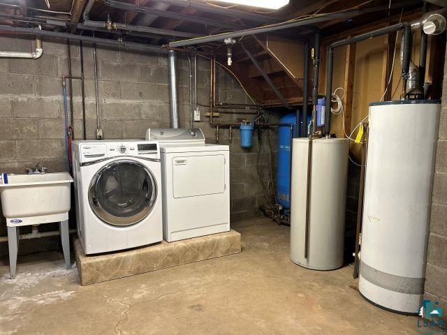 8353 Mannik Road Iron River, WI 54847 - Photo 21 of 48 Unfinished below grade area with water heater, washing machine and clothes dryer, and a water pressure tank