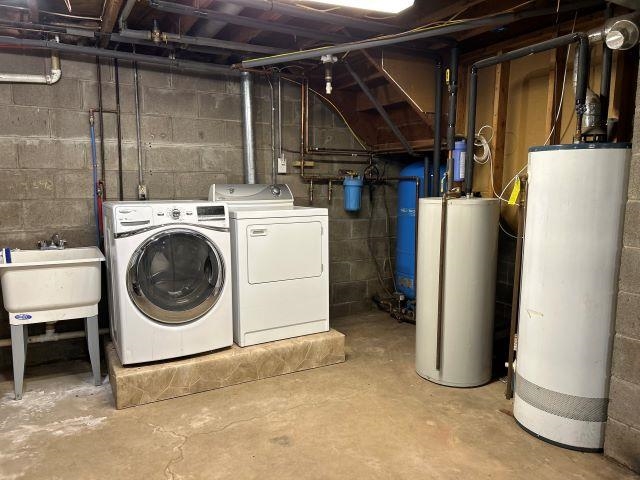 8353 Mannik Road Iron River, WI 54847 - Photo 21 of 48 Unfinished below grade area with water heater, washing machine and clothes dryer, and a water pressure tank