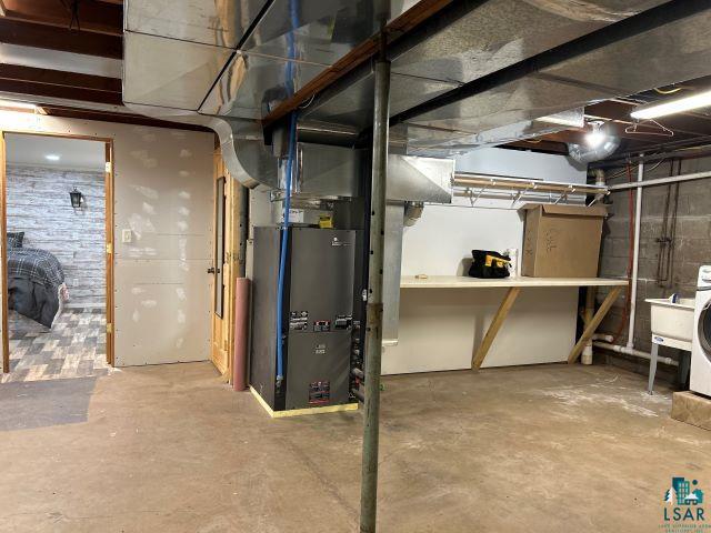 8353 Mannik Road Iron River, WI 54847 - Photo 22 of 48 Unfinished basement featuring washer / dryer and heating unit