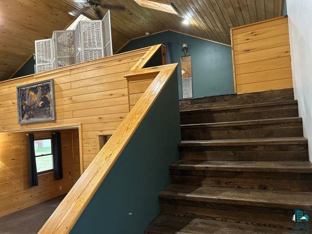 8353 Mannik Road Iron River, WI 54847 - Photo 31 of 48 Stairs featuring wooden walls, wood ceiling, and vaulted ceiling