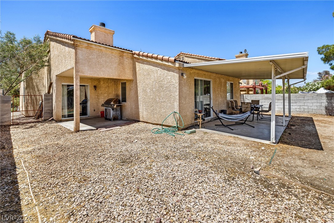 1624 Palmae Way Las Vegas, NV 89128 - Photo 15 of 18 This desert-adapted dwelling features a covered patio with a paved surface and ample space for outdoor relaxation.