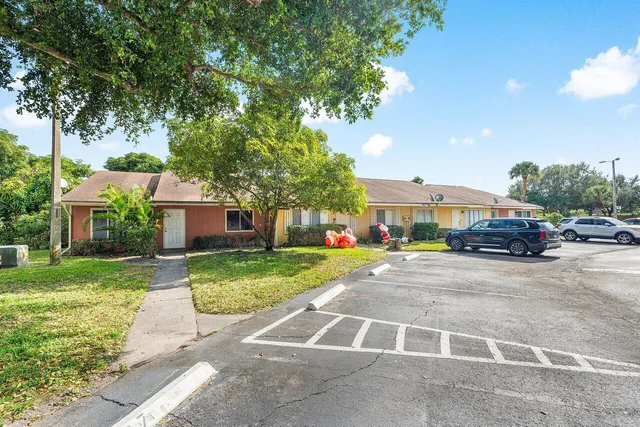 a car parked in front of a house and a yard