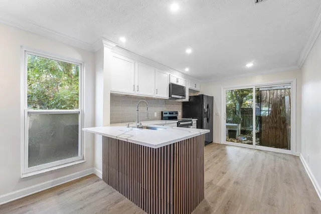 a kitchen with a sink stove and cabinets