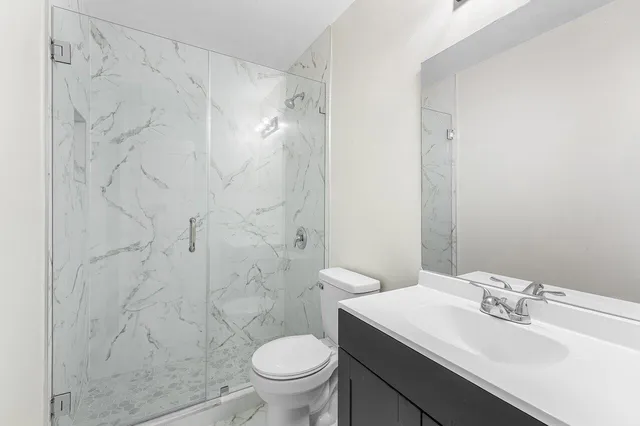 a bathroom with a sink toilet and shower