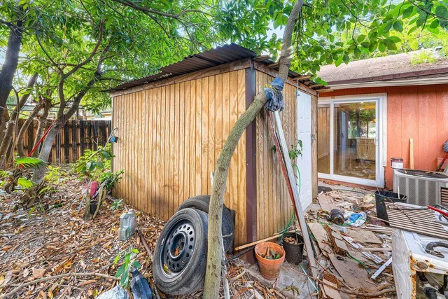 a backyard of a house with table and chairs