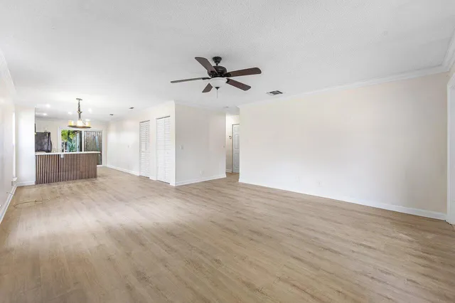 a view of a kitchen with a sink and a refrigerator