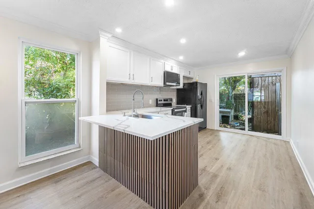 a kitchen with a sink stove and cabinets