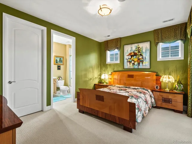 a bedroom with a bed and wall painting