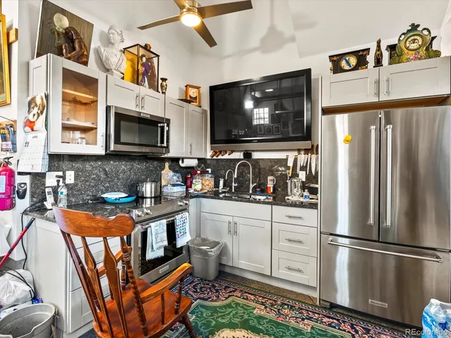 a kitchen with stainless steel appliances granite countertop a refrigerator stove and microwave
