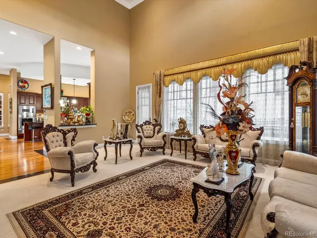 a living room with furniture and a floor to ceiling window