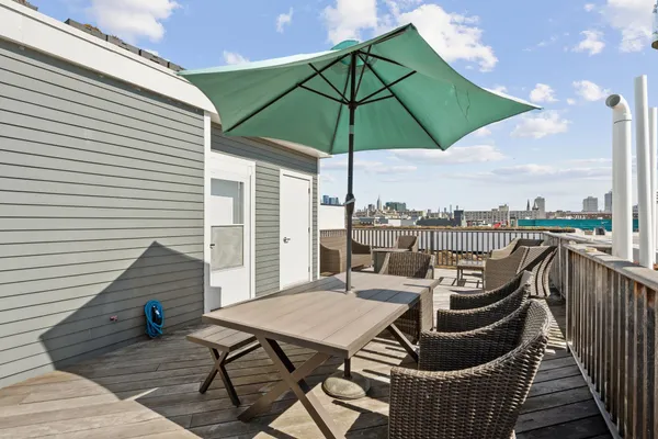 a view of a roof deck with furniture