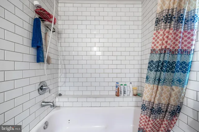 a bathroom with a bathtub and shower