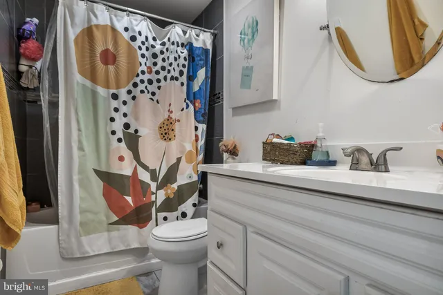 a bathroom with a sink mirror and vanity