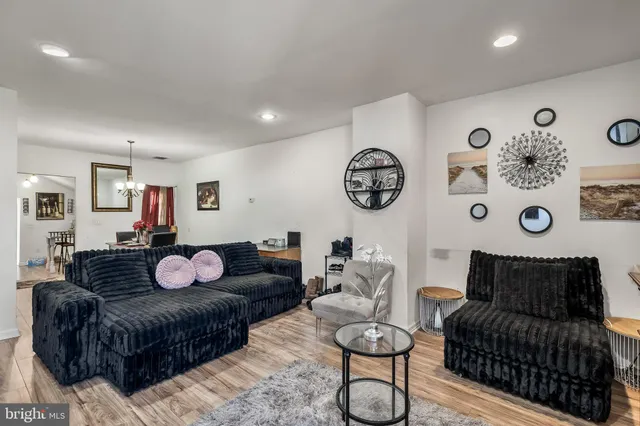 a living room with furniture and wall paintings
