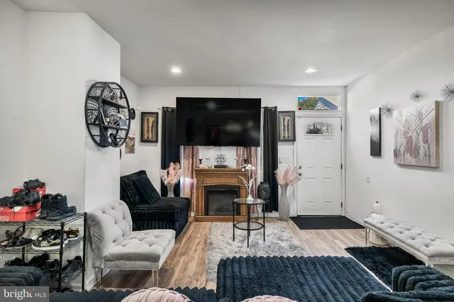 a living room with furniture a fireplace and a flat screen tv