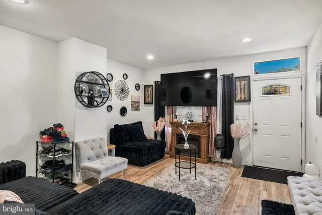 a living room with furniture and a flat screen tv