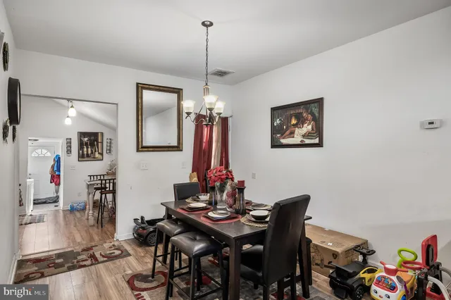 a view of a dining room with furniture wooden floor and a chandelier