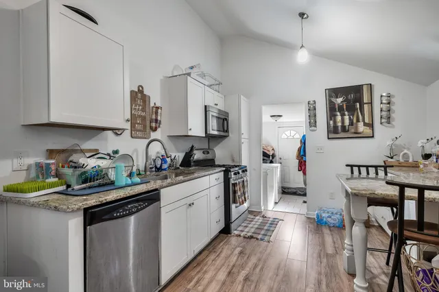 a kitchen with a sink appliances and wooden cabinets