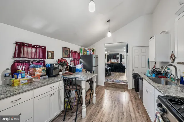 a open kitchen with stainless steel appliances granite countertop a stove and cabinets