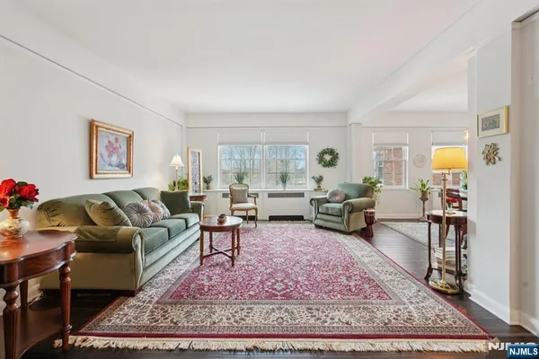 a living room with furniture rug and a table