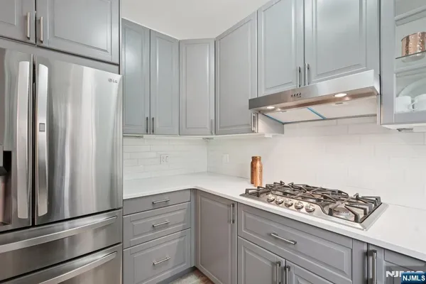 a kitchen with stainless steel appliances a stove and a refrigerator