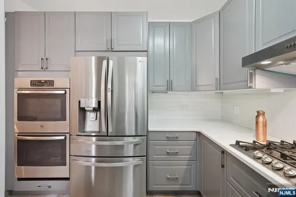 a kitchen with appliances and cabinets