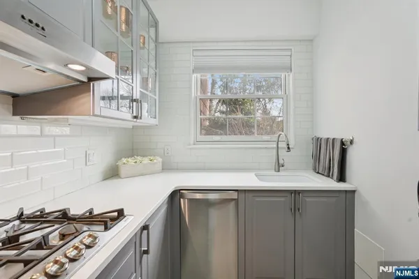 a bathroom with a granite countertop sink and a window