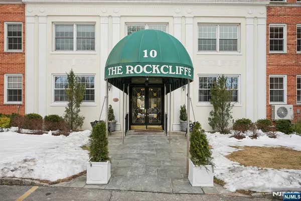 a front view of a building with a garden