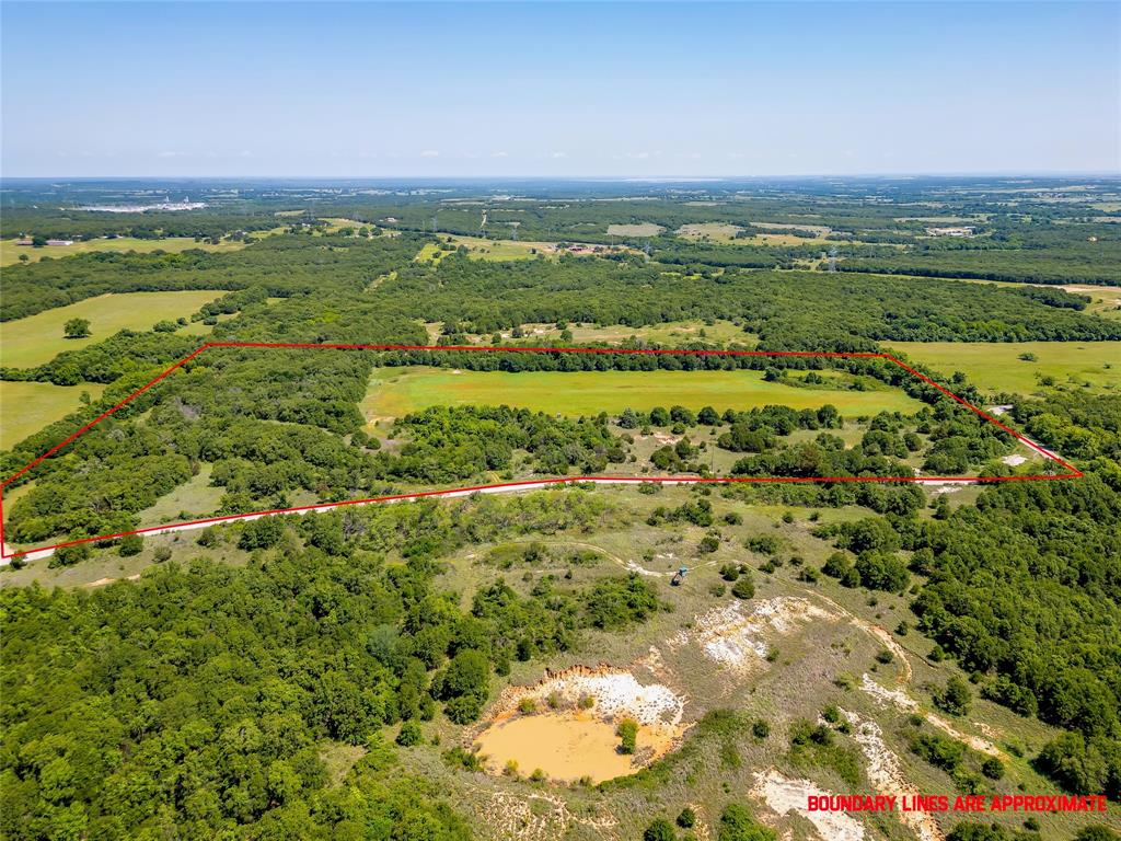 613 County Road 3848 Poolville, TX 76487 - Photo 2 of 40 a view of a city with ocean view