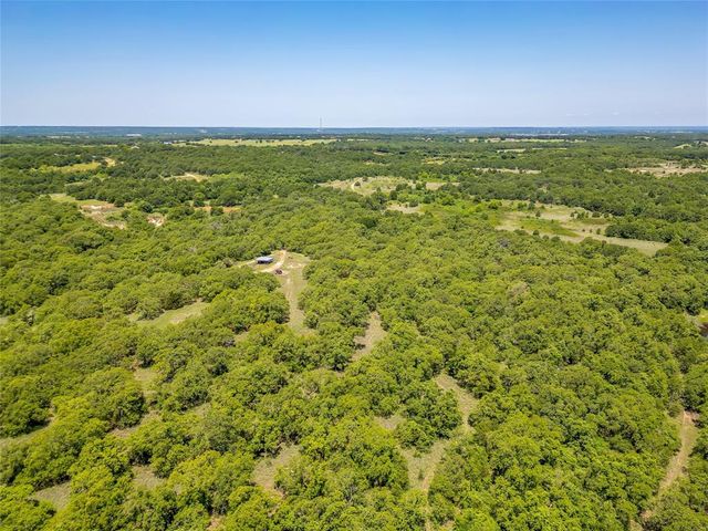 a view of a field with an ocean