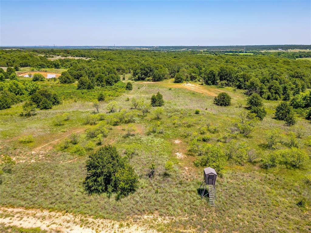 613 County Road 3848 Poolville, TX 76487 - Photo 33 of 40 a view of a yard with an outdoor space