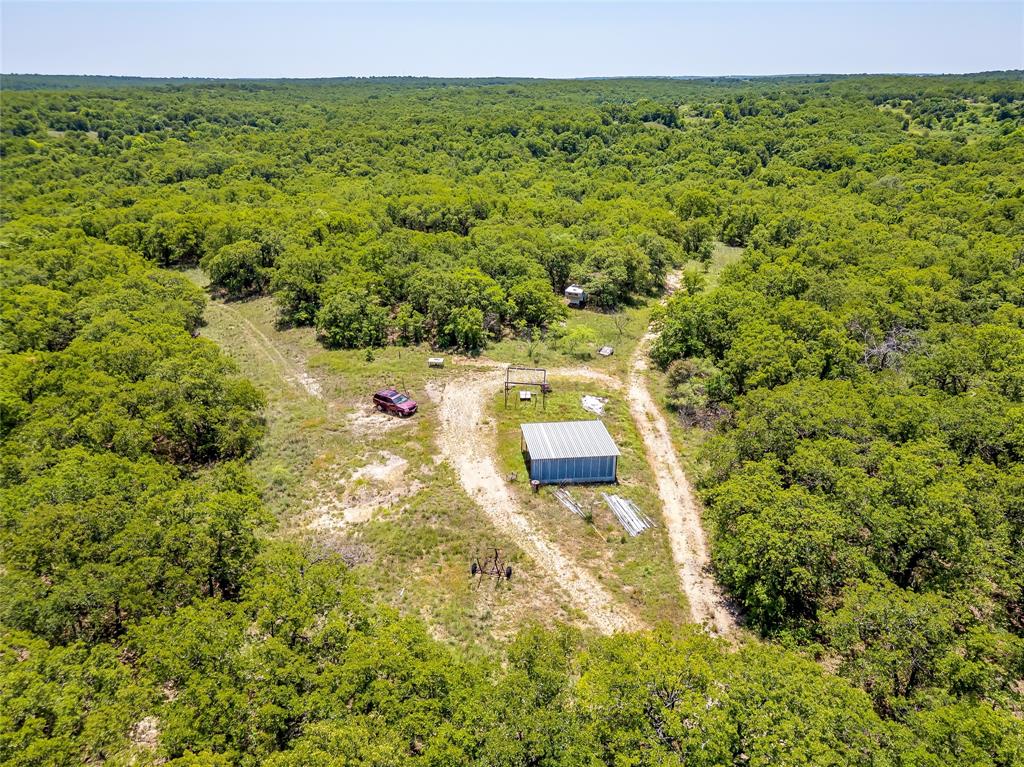 613 County Road 3848 Poolville, TX 76487 - Photo 39 of 40 a view of a yard with an outdoor space