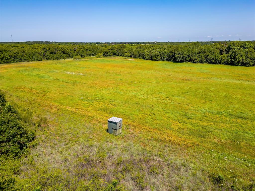 613 County Road 3848 Poolville, TX 76487 - Photo 9 of 40 a view of an ocean from a yard